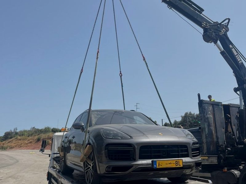 Porsche Cayenne lifted by crane onto a recovery flatbed